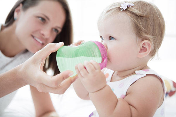 Little girl drinks infant formula