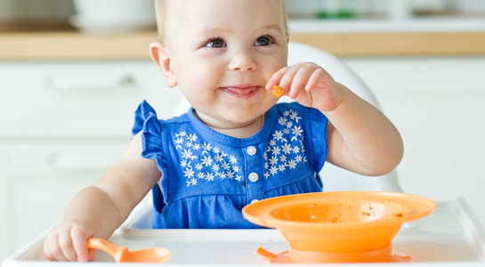 Little girl eats a porridge 
