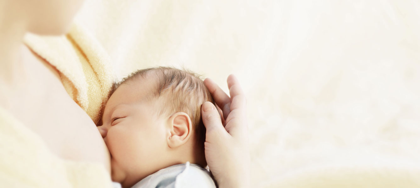 A mother breast-feeding her baby