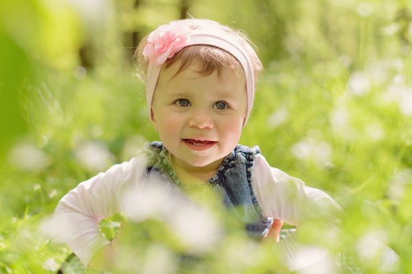 Una niña feliz con un pañuelo en la cabeza corriendo por la pradera