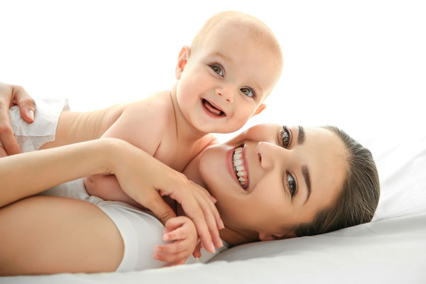 Baby and mother smiling