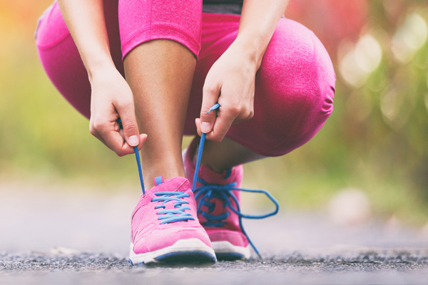 Woman tying her sneakers