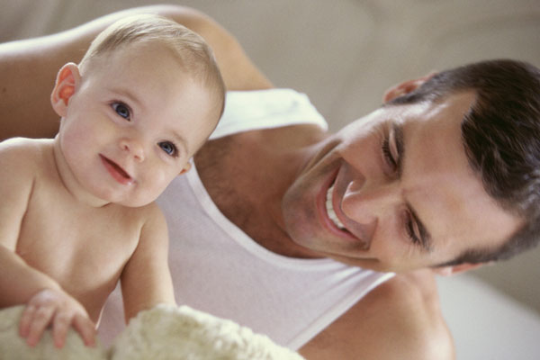 Baby playing with his father